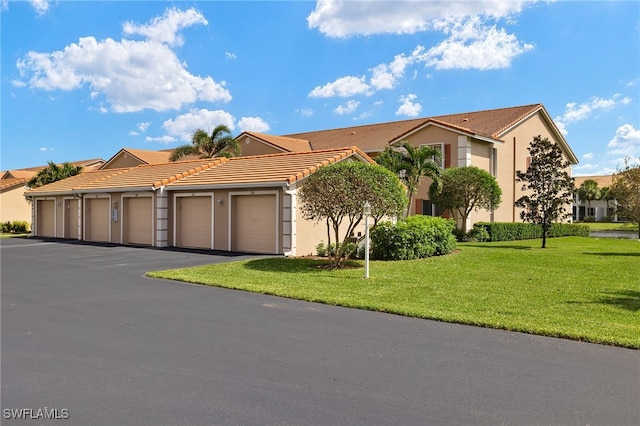 view of front of house featuring a garage and a front lawn