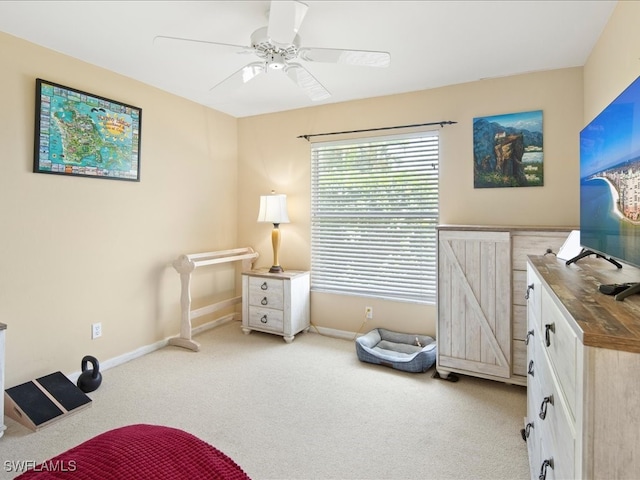 sitting room featuring light carpet and ceiling fan