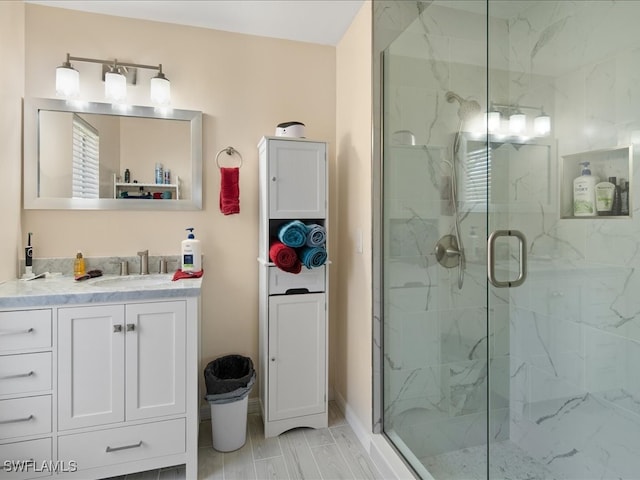 bathroom with vanity and a shower with door