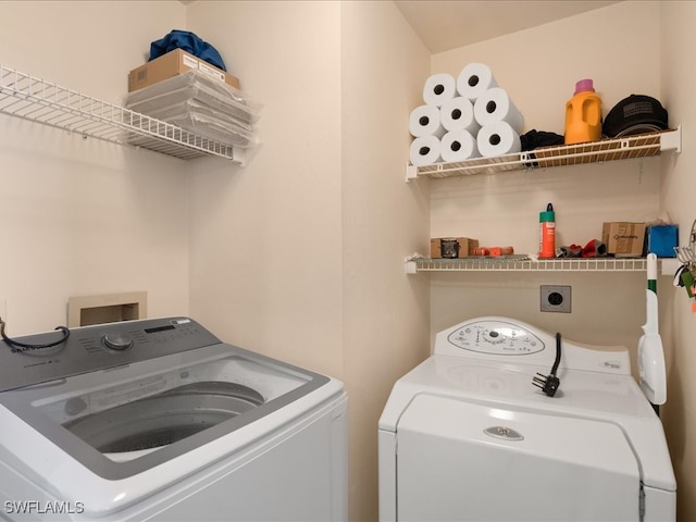 clothes washing area with washing machine and clothes dryer