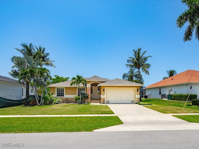 view of front of home with a front yard and a garage