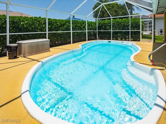 view of swimming pool with a lanai