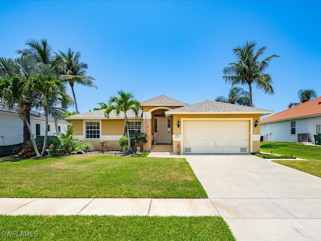 view of front of home featuring a front yard, central AC unit, and a garage