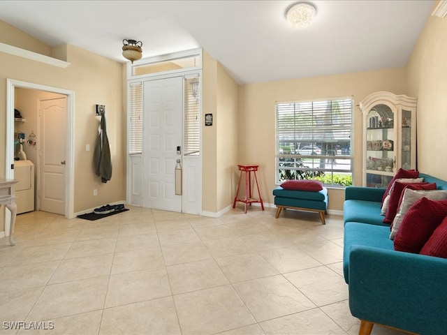 tiled entrance foyer featuring washer / clothes dryer