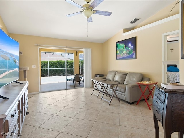 living room with lofted ceiling, light tile patterned floors, and ceiling fan