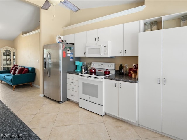 kitchen featuring lofted ceiling, ceiling fan, light tile patterned floors, white cabinetry, and white appliances