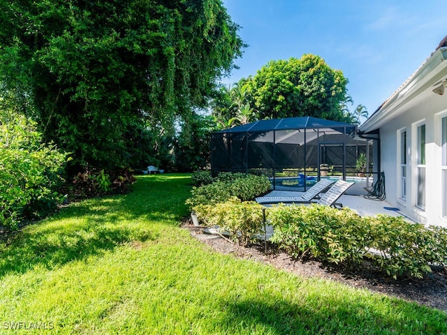 view of yard featuring a patio, an outdoor pool, and glass enclosure