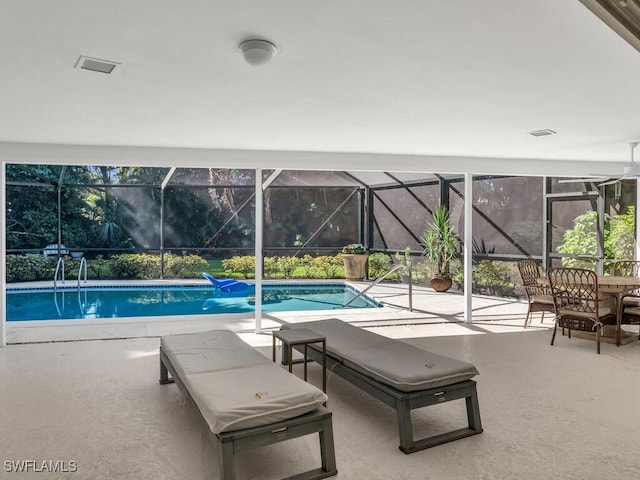outdoor pool with a patio area and glass enclosure