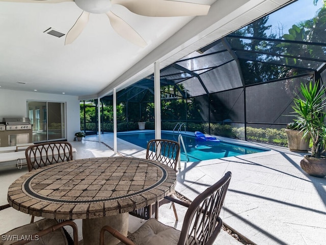 outdoor pool with glass enclosure, a ceiling fan, outdoor dining area, and a patio area
