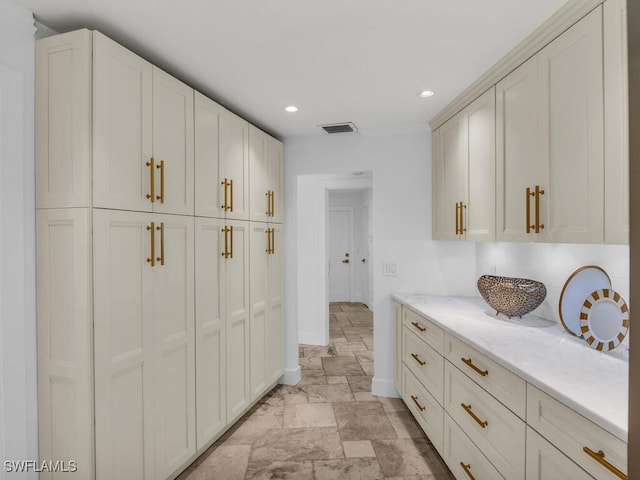interior space with stone finish flooring, visible vents, recessed lighting, and baseboards