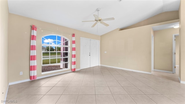 tiled spare room with lofted ceiling and ceiling fan