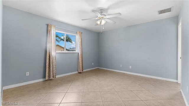 spare room featuring light tile patterned flooring and ceiling fan