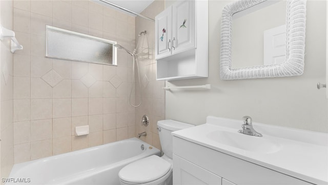 full bathroom featuring toilet, tiled shower / bath, and vanity