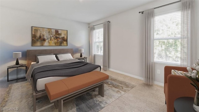 bedroom featuring light colored carpet and baseboards