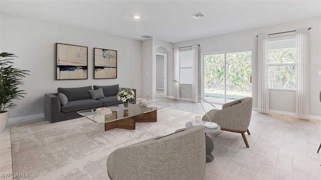 living area featuring baseboards and visible vents