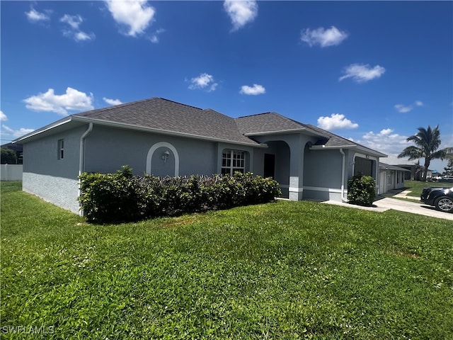 view of front of home with a front lawn and a garage