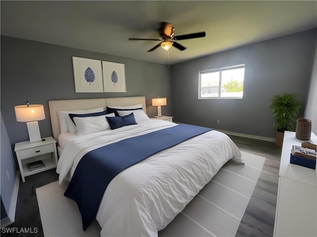 bedroom with hardwood / wood-style floors and ceiling fan