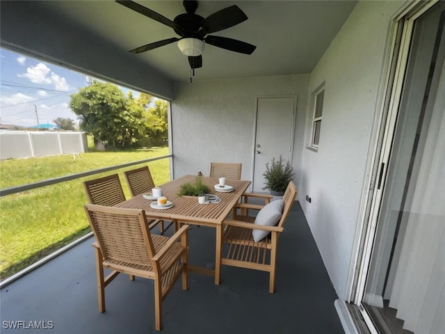 sunroom featuring ceiling fan