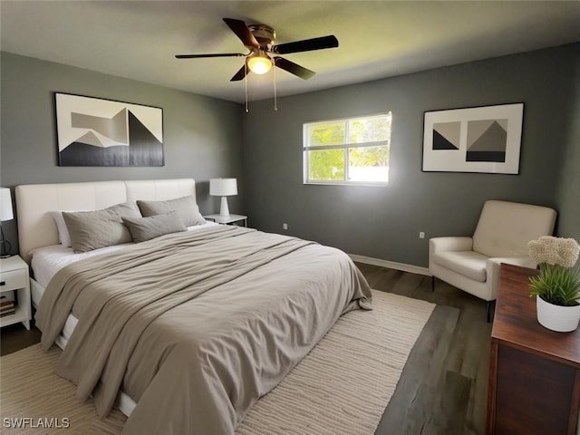 bedroom with ceiling fan and dark wood-type flooring