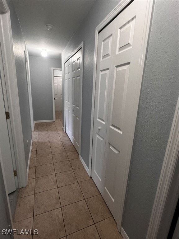 corridor featuring light tile patterned flooring