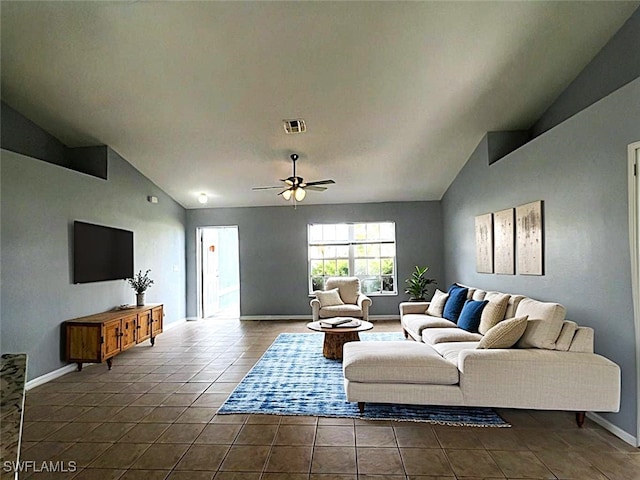 living room with vaulted ceiling, dark tile patterned floors, and ceiling fan