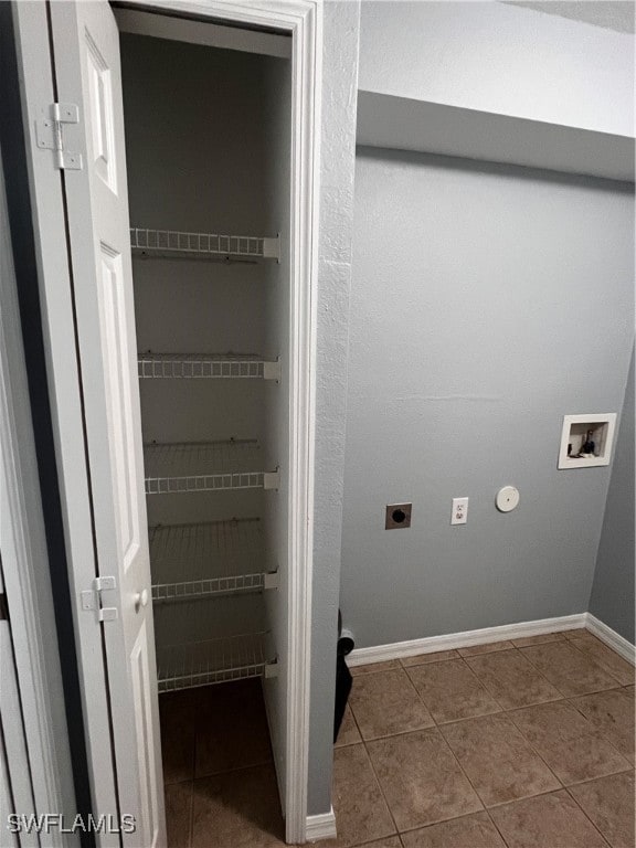 washroom featuring hookup for an electric dryer, hookup for a washing machine, and tile patterned floors