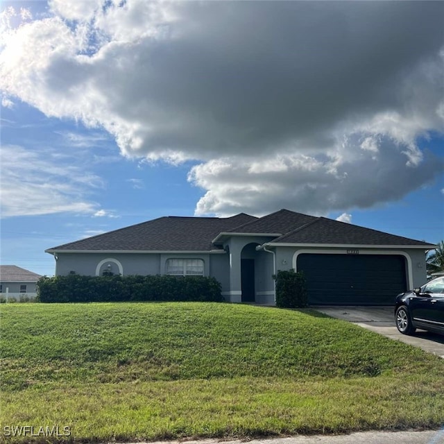 single story home with a front yard and a garage