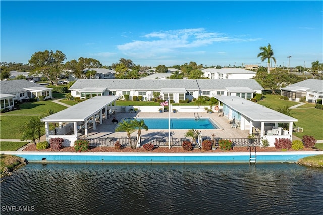 rear view of property with a patio, a water view, and a community pool