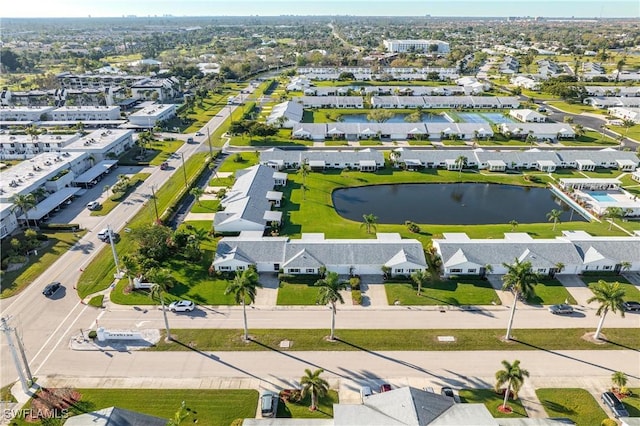 drone / aerial view with a water view and a residential view