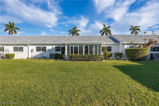 back of property featuring a yard and stucco siding