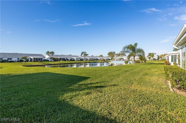 view of yard featuring a water view and a residential view