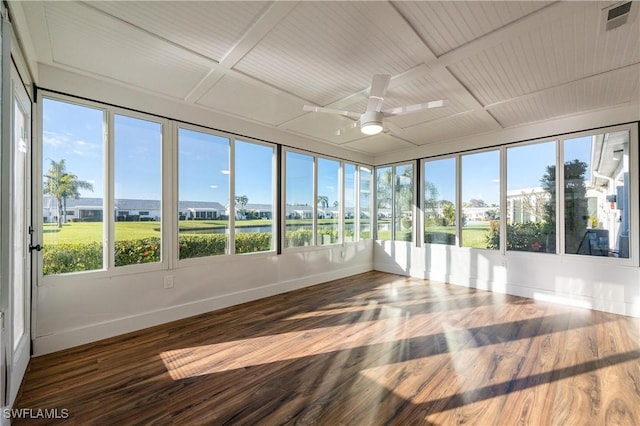 unfurnished sunroom featuring visible vents, baseboards, a ceiling fan, and wood finished floors