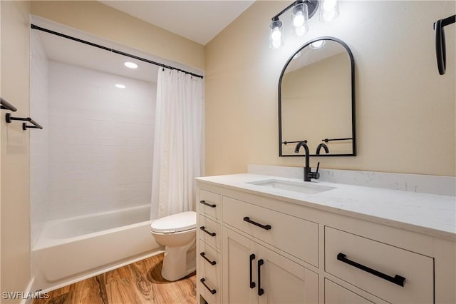 full bathroom featuring toilet, shower / bath combo with shower curtain, vanity, and wood finished floors