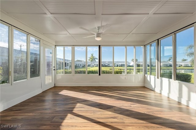 unfurnished sunroom with baseboards, a ceiling fan, and wood finished floors