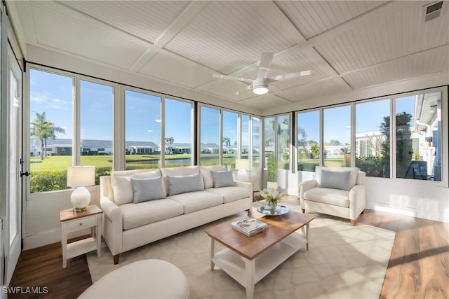 sunroom / solarium with visible vents, baseboards, and wood finished floors