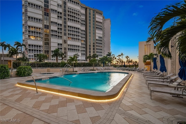 pool at dusk with a patio