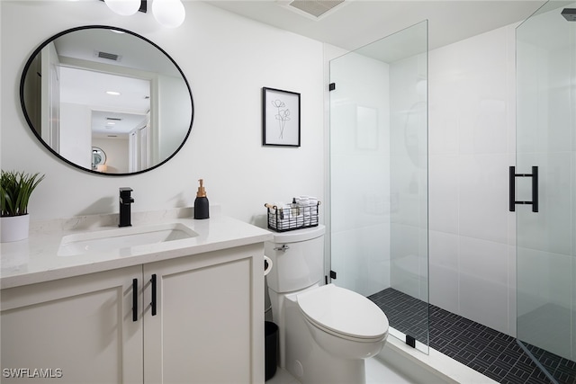 bathroom featuring an enclosed shower, vanity, and toilet