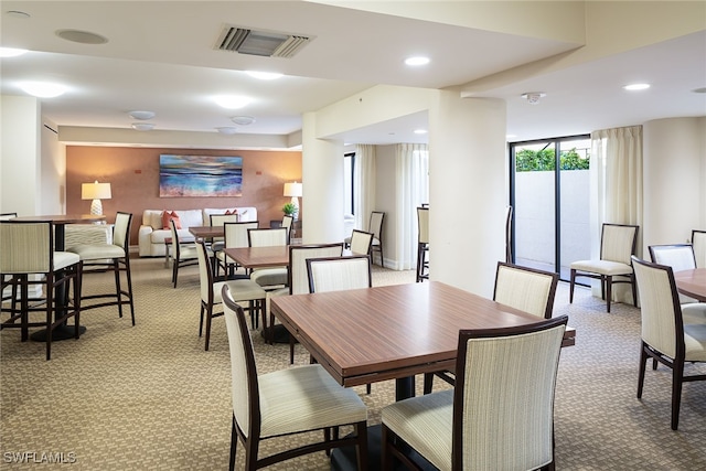 dining room featuring light carpet