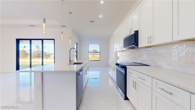 kitchen with hanging light fixtures, sink, white cabinetry, appliances with stainless steel finishes, and tasteful backsplash