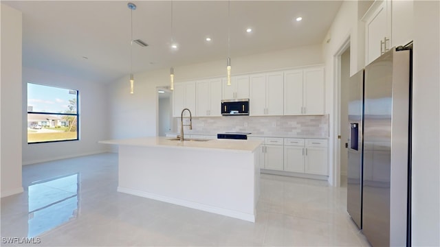 kitchen featuring white cabinetry, decorative light fixtures, a kitchen island with sink, and stainless steel appliances