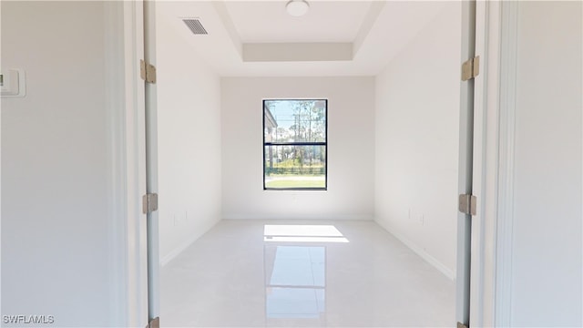 empty room with a raised ceiling