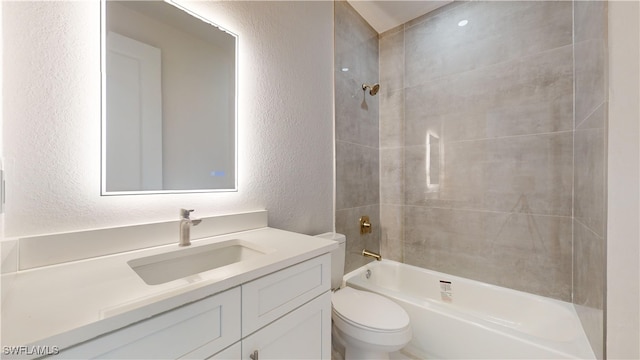 full bathroom with vanity, toilet, and tiled shower / bath