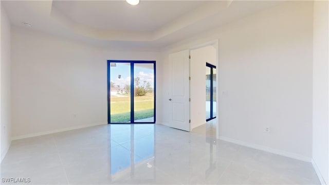 unfurnished room with a raised ceiling