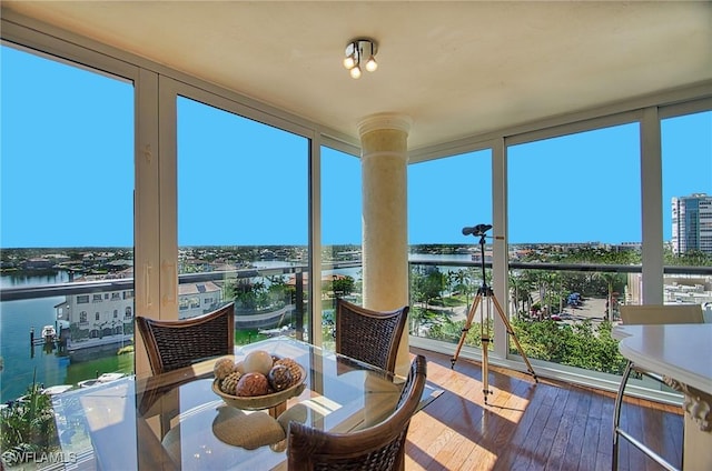 4031 Gulf Shore Blvd N Unit 8E, Naples, FL 34103 - sunroom / solarium featuring hardwood / wood-style floors, a water view, and expansive windows