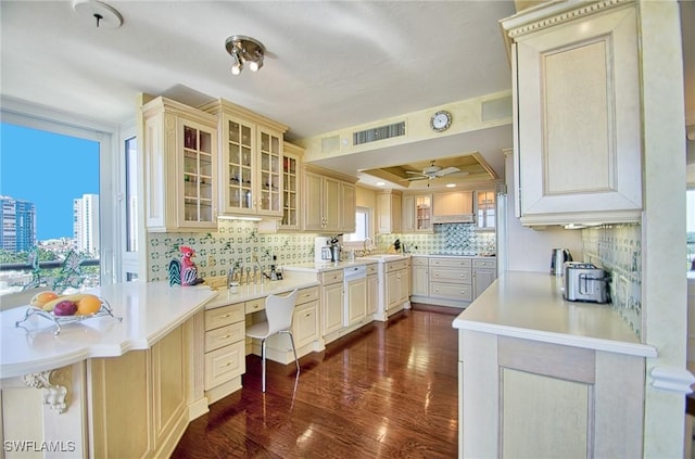 4031 Gulf Shore Blvd N Unit 8E, Naples, FL 34103 - kitchen featuring visible vents, dark wood-style flooring, a tray ceiling, tasteful backsplash, and a sink