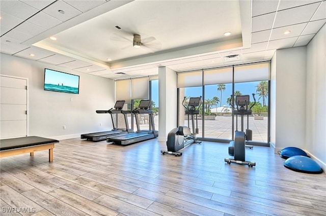 4031 Gulf Shore Blvd N Unit 8E, Naples, FL 34103 - gym featuring a tray ceiling, ceiling fan, and wood finished floors