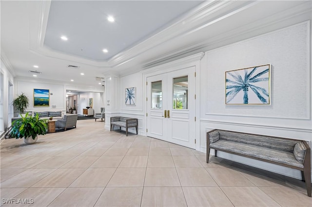 entryway with crown molding, light tile patterned floors, a tray ceiling, and recessed lighting