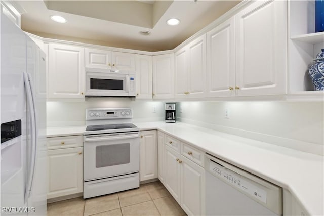 kitchen featuring white cabinets, white appliances, and light tile patterned floors