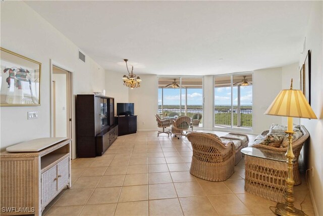 living room featuring a notable chandelier and light tile patterned floors