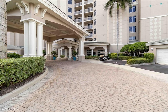 view of home's community with decorative driveway